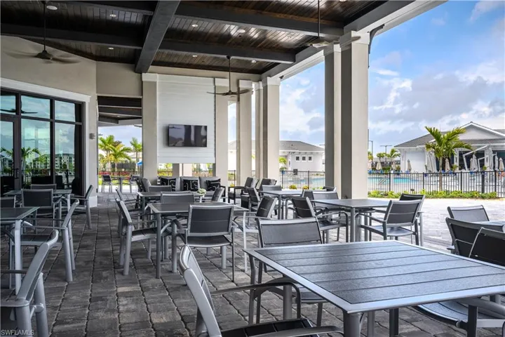 View of patio featuring ceiling fan, fence, and outdoor dining space