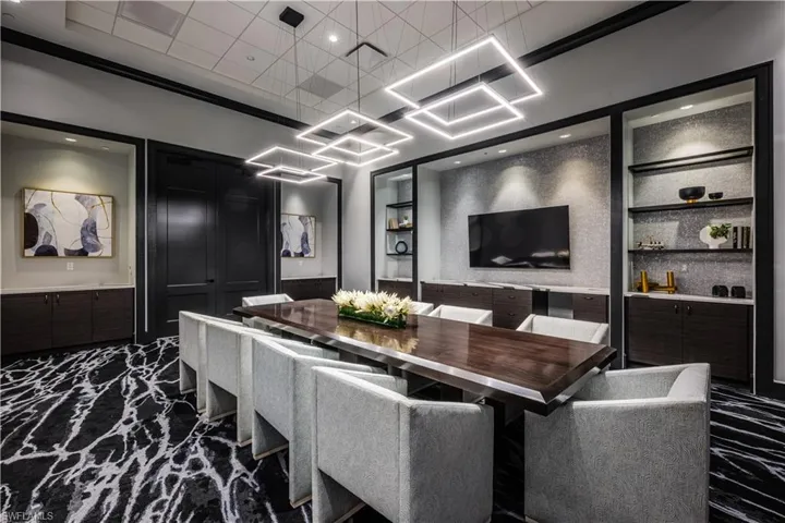 Dining space with built in features and marble finish floor