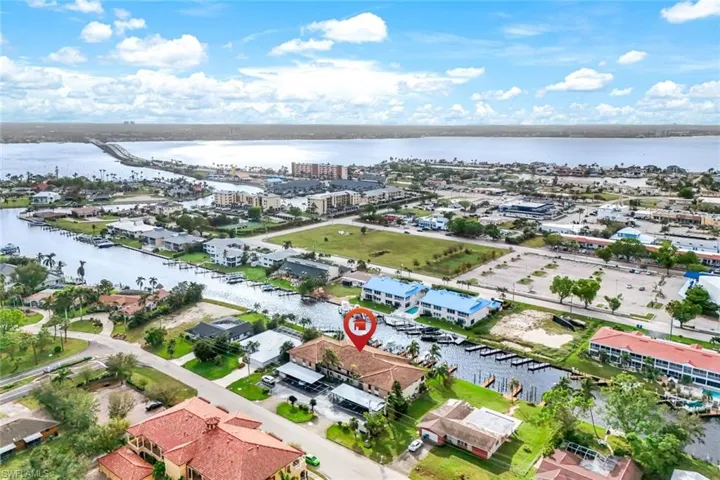 Birds eye view of property with a water view