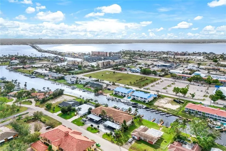 Birds eye view of property with a water view