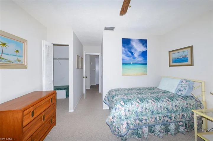 Spacious guest bedroom features a walk-in closet and 2 large windows for ample natural light and a view to the private courtyard.