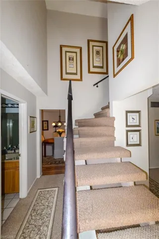 Entry Foyer shows Staircase to right and hallway with full bath to left. Leads to Dining room and Florida room.
