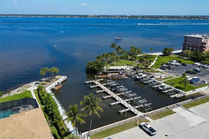 Aerial View of Community Marina shows Private Sandy Beach on River Bank, Pavilion, Park, & Boat Ramp. Pier was damaged and is currently being rebuilt. Current picture shows equipment in place for rebuild of Fishing Pier.