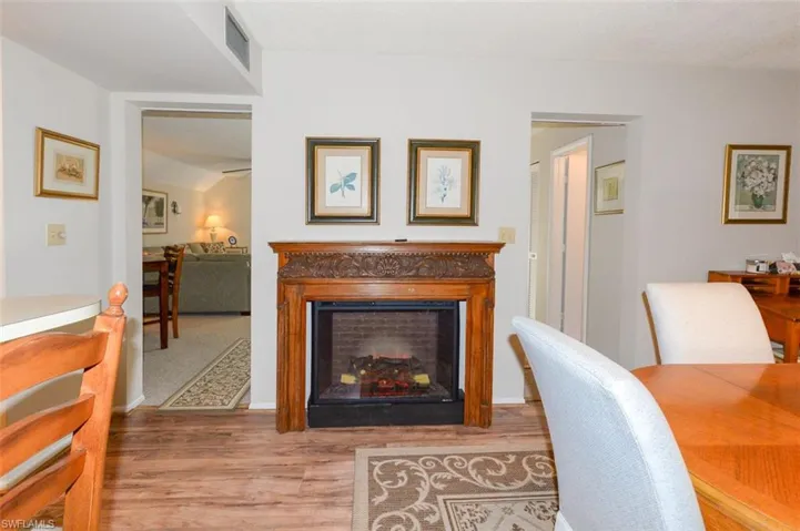 Dining room shows entry to living room to the left and entry to hallway leading to full bathroom and entry foyer to the right