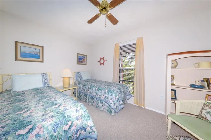 Spacious guest bedroom features 2 large windows for ample natural light and a view to the private courtyard.