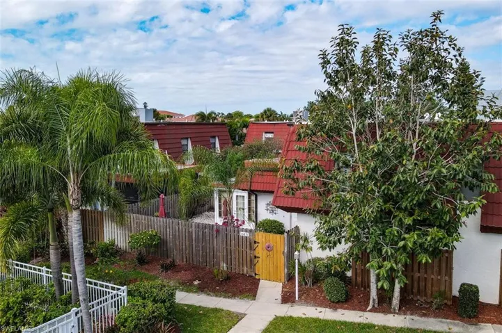 Aerial View of Front of Townhome shows Pool Area to left of the townhome entrance gate. Includes 2 assigned parking spaces in front of the gate.