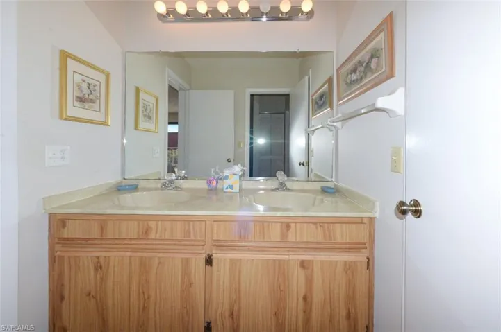 View of Primary Bathroom vanity with double sinks from the hallway door.