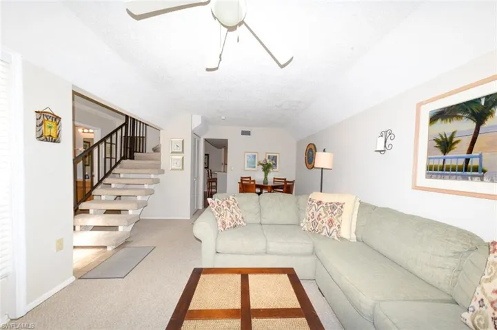 Spacious Living Room looking toward Breakfast area and kitchen to right and Staircase and entry foyer to left