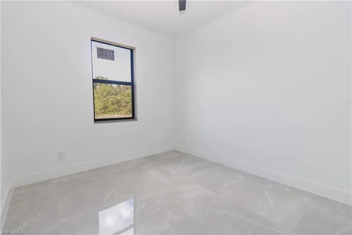 Unfurnished room featuring baseboards