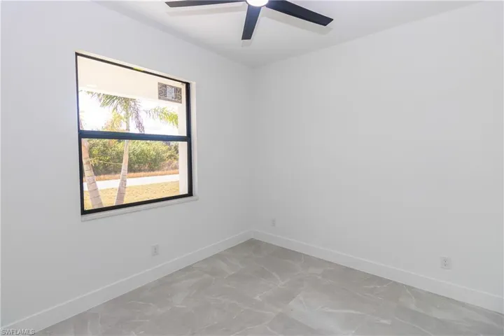 Unfurnished room with baseboards