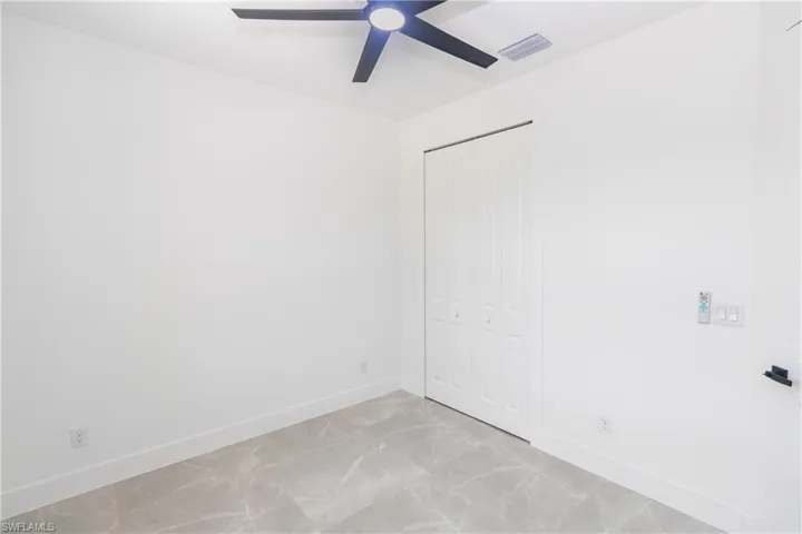 Unfurnished bedroom featuring a closet and a ceiling fan