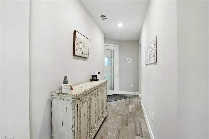 Corridor featuring light wood-style flooring and recessed lighting