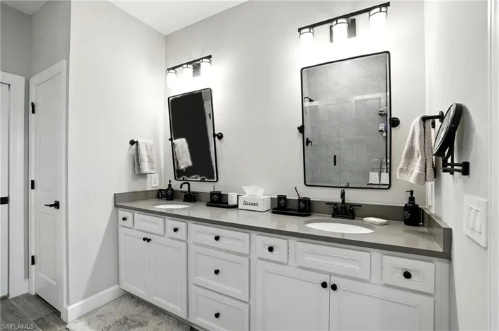 Bathroom with a stall shower and double vanity