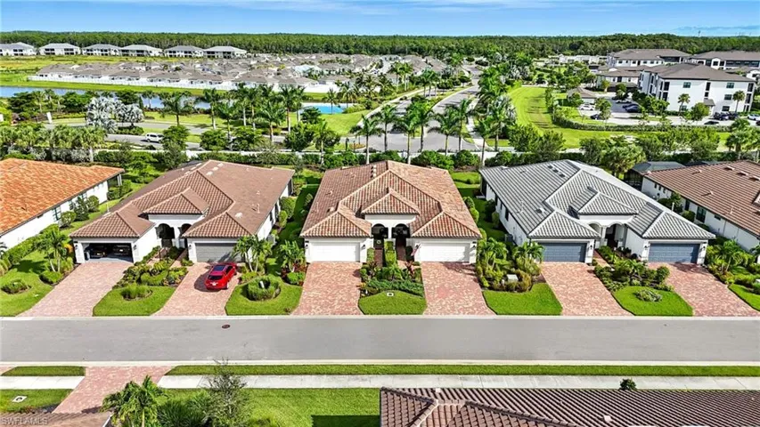 Aerial perspective of suburban area featuring a nearby body of water