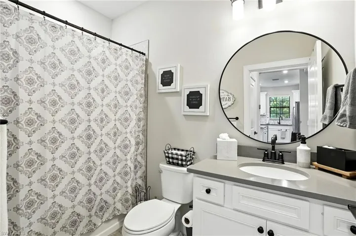 Full bathroom featuring vanity and shower / bath combination with curtain