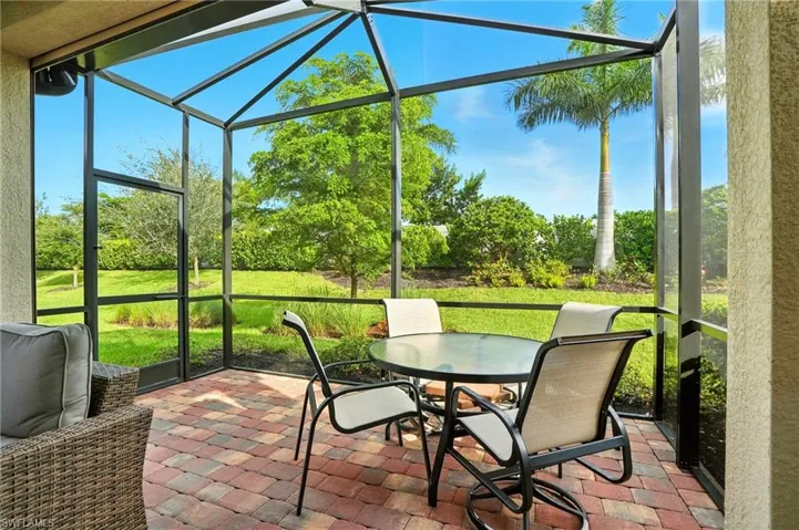Sunroom featuring healthy amount of natural light and outdoor dining area