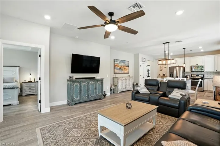 Living area with ceiling fan, recessed lighting, and light wood-type flooring