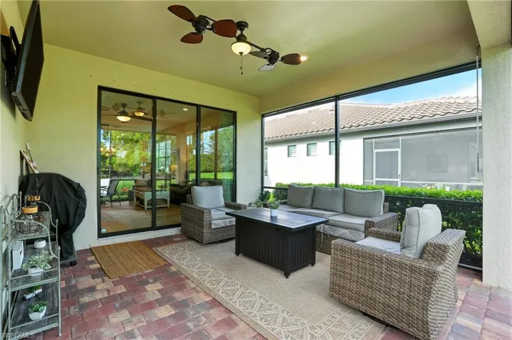 Sunroom / solarium with an outdoor hangout area, healthy amount of natural light, and a ceiling fan