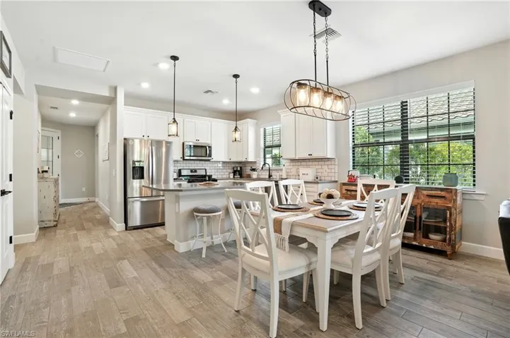 Dining space featuring light wood-style flooring and recessed lighting