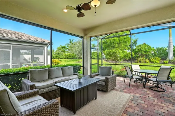 Sunroom / solarium with a ceiling fan, an outdoor living space, and outdoor dining area