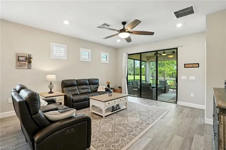 Living area with healthy amount of natural light, recessed lighting, light wood-style flooring, and a ceiling fan