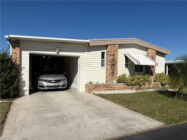View of front of house featuring a front yard and a garage