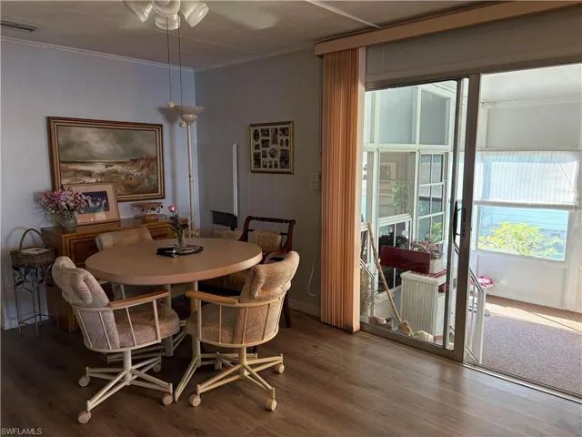 Dining room featuring hardwood / wood-style floors and ornamental molding