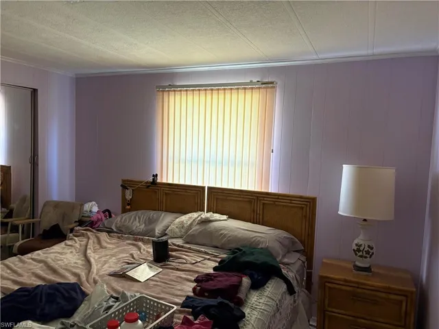 Bedroom featuring wood walls