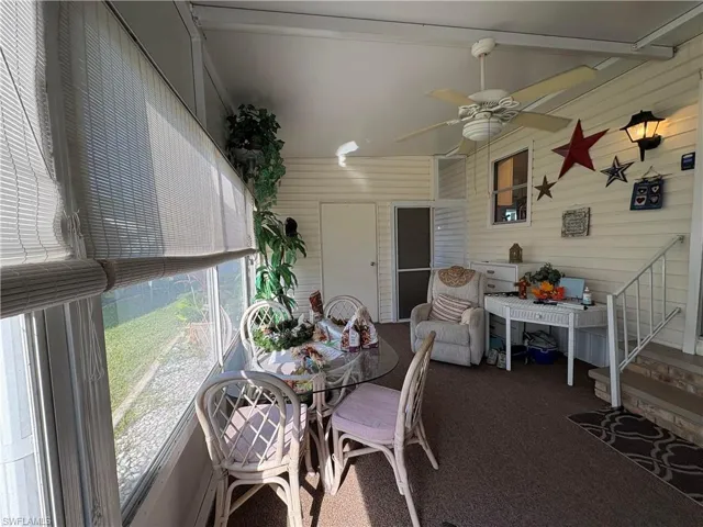Sunroom / solarium featuring ceiling fan