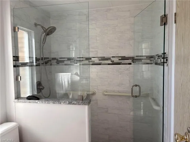 Bathroom with toilet and walk in shower