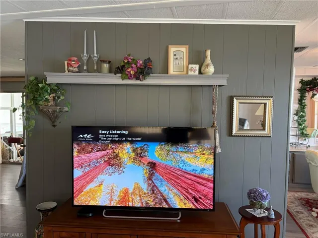 Details featuring wood walls and hardwood / wood-style flooring