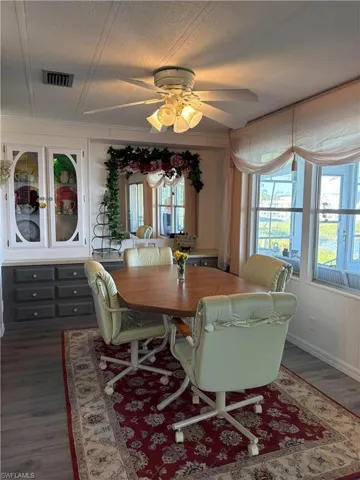 Dining space featuring ceiling fan, dark hardwood / wood-style floors, and a textured ceiling