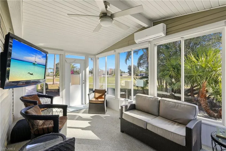 Sunroom / solarium featuring a ceiling fan, an outdoor living space, and a wall mounted air conditioner