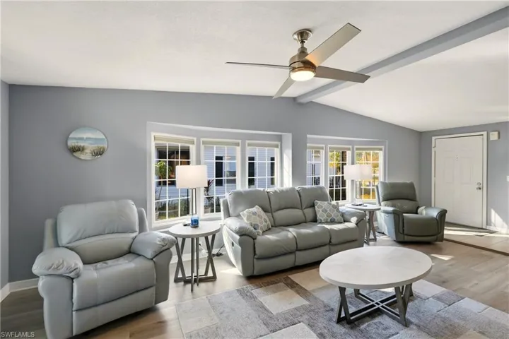 Living area with wood finished floors and ceiling fan