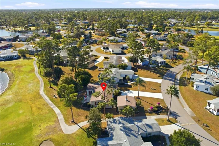 Aerial perspective of suburban area featuring a nearby body of water
