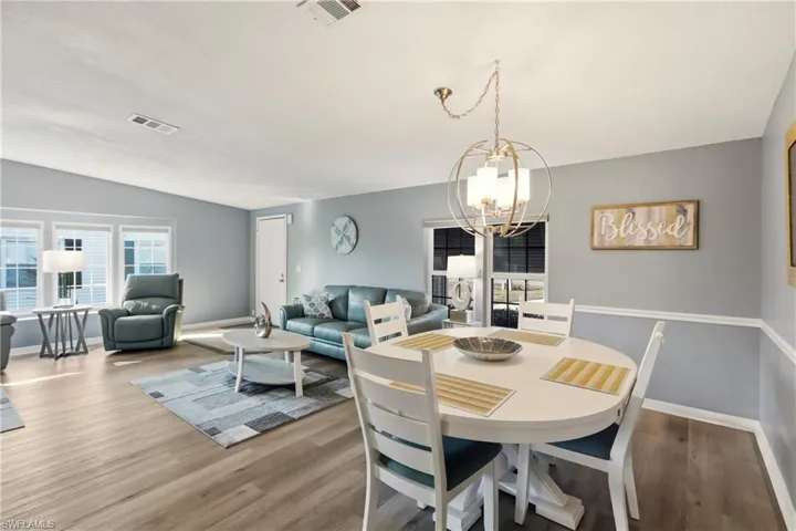 Dining area featuring a chandelier and wood finished floors