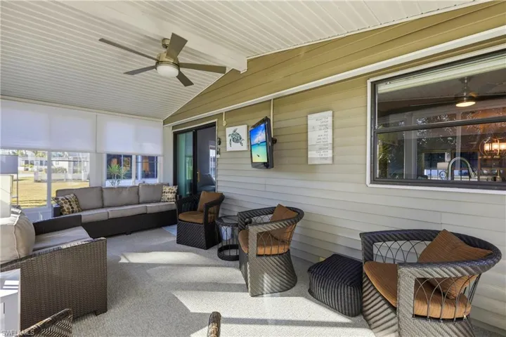 Sunroom with a ceiling fan and an outdoor living space