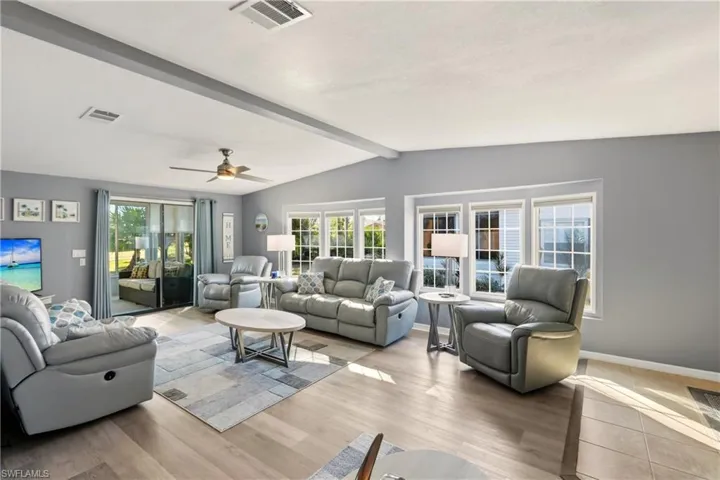 Living area with light wood-type flooring and ceiling fan