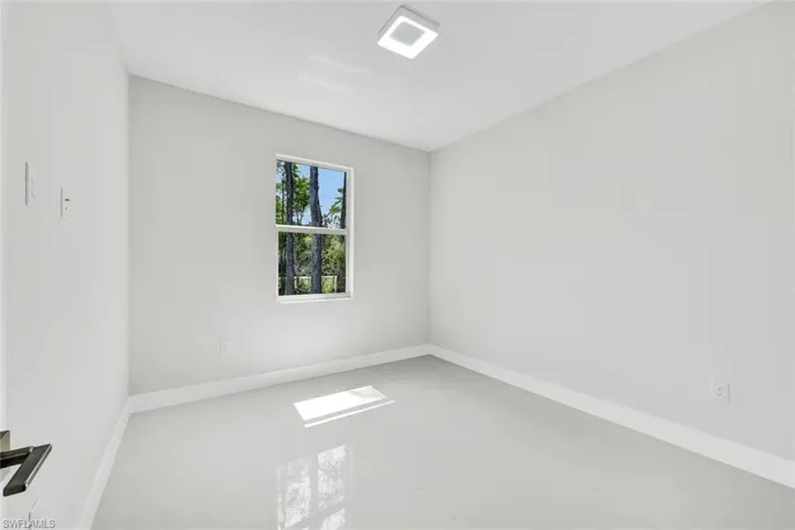 Unfurnished room with concrete flooring