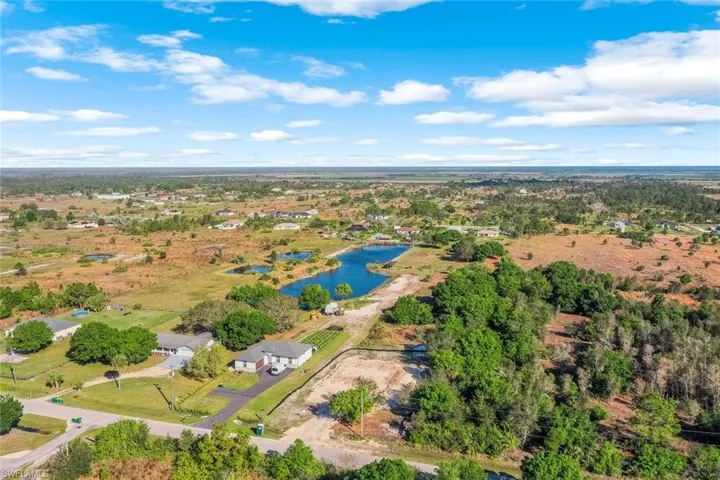 Birds eye view of property with a water view