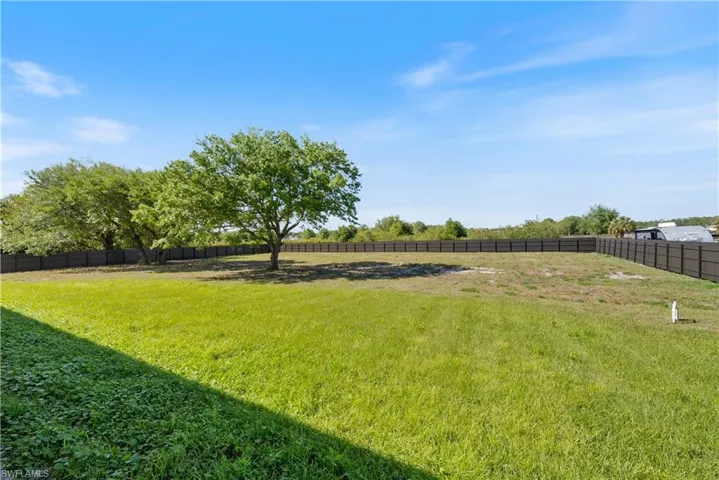 View of yard featuring fence