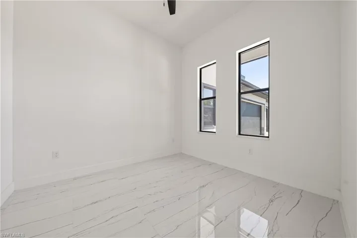 Unfurnished room featuring baseboards and a ceiling fan