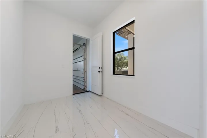 Spare room with baseboards and marble finish floor
