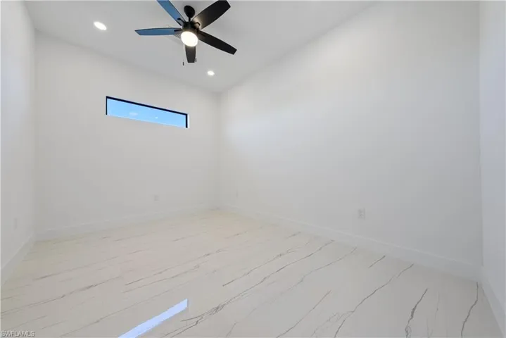 Spare room with recessed lighting, a ceiling fan, and baseboards