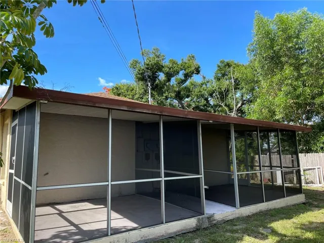 Back of house with a sunroom