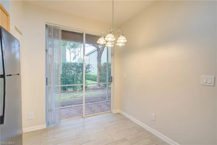 Unfurnished dining area with lofted ceiling and a notable chandelier