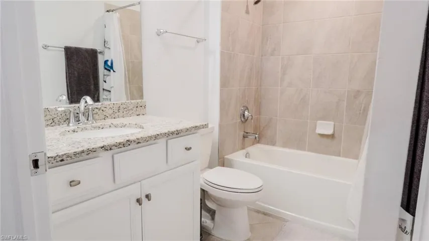 Bathroom with vanity and shower / bath combo with shower curtain
