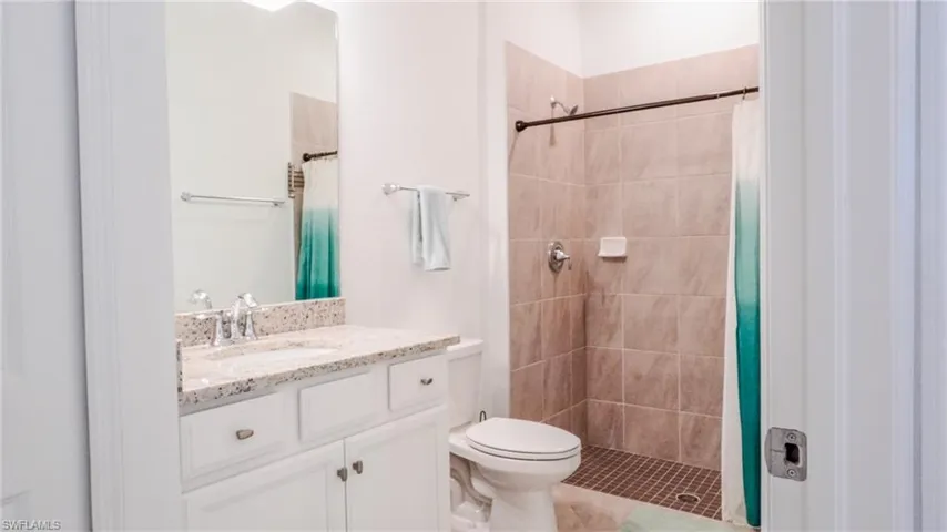 Full bath featuring vanity and a shower stall