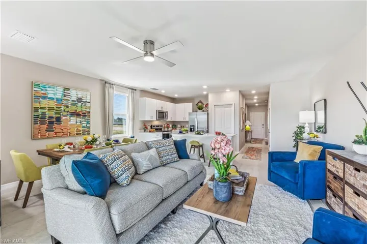 Living room featuring ceiling fan and light hardwood / wood-style flooring