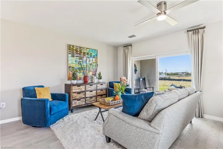 Living room featuring light hardwood / wood-style flooring and ceiling fan